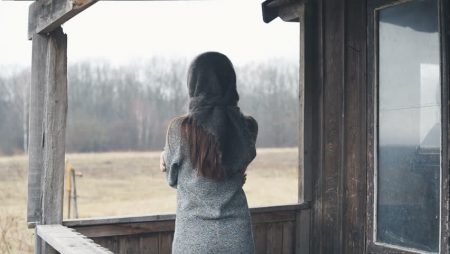 Woman Standing On Porch Alone