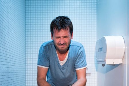 man sitting on toilet
